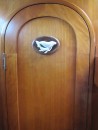 Tongan carved whale made of cow bone, on workshop door