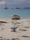 A perfectly safely anchored dinghy on the beach