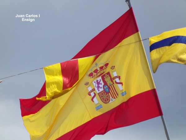 Warship Juan Carlos I ensign and signal flags whilst moored in A Coruna port