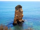 A rocky outcrop just off the beach which is shaped like a man