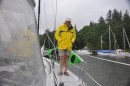 Captain Flip-Flop washing the boat in the rain.
