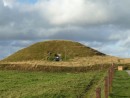 Maes Howe. A hollow mound with a stone-lined burial chamber inside. Built a long time ago but raided by the Vikings who left lots of Runic graffiti. Re-Discovered in 1836 and excavated. 
