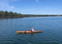 A visitor while we were anchored on the Pemmaquanan River.: His name is Jim and has a house in nearby Pembroke. He also has a very nice kayak he built by himself. He loved the boat and stopped by for a chat!