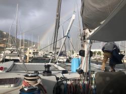 Rainbow at Nanny Cay after a squall: and one of the B&G guys working in the mast area for the new awnings.