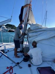 Taking off the main sail for repair: Taking off the main sail for repair