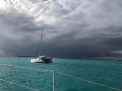 A heavy squall at the horizon in the Tobago Cays giving an eerie light to the whole area. You can see the stark profiles of the palm trees on Petit Tobac.