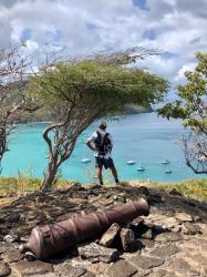 Pausing to take a peek at Chatam Bay during a hike: in Union Island. We tried to use a local mooring and our anchor to tie our dinghy off the beach - our dinghy weighs about 300 lbs motor and all, so it