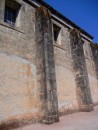 The outside wall of the church.