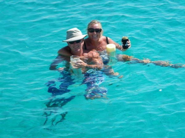 Normans Cay. Denny & Becky floating on noodles with a cold beer.