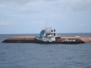 Tug America and upturned barge