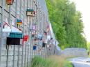 An amazing sight to see in the middle of nowhere with at least 100 bird boxes mounted to the wall of a roadcut in Maine between the towns of Caratunk and Moscow, Maine.  I have not been able to find out any information on why they are there.  