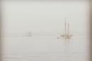 The fog arrives.  This shows the lighthouse at the end of the Rockland Breakwater. Maine, USA