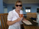 Vicki with her rose wine and bag of pink sand