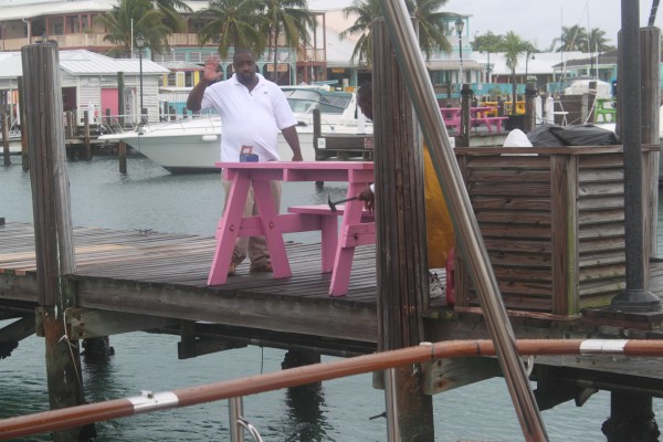 Dock guys nailing down our closely pink picnic table on the dock near us