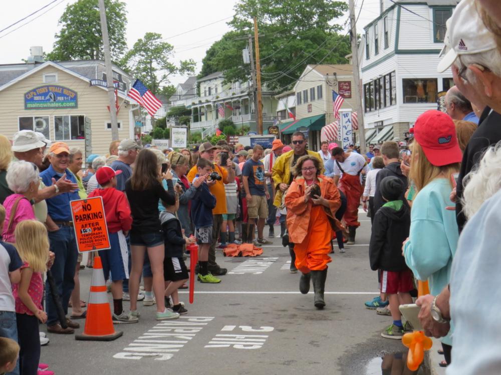 The relay cod race through Boothbay.  Participants need to wear oilskins and race 4 cod around the block.