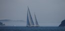 Huge yacht sailing in Somes Sound with fog coming towards it, Maine