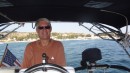 Don at the helm as Koinonia motors through a very windless Med.