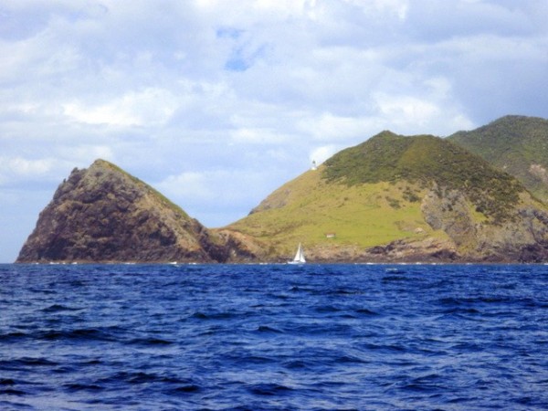 The Cape Brett lighthouse, with a sailboat in the foreground