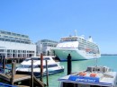 A cruise ship docked next to the waterfron Hilton
