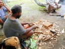 Another carver from a neighboring village, working on a dolphin.