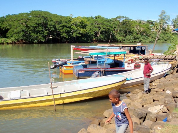 Local fishing boats hauled up on the river bank behind the fish market in Labasa.