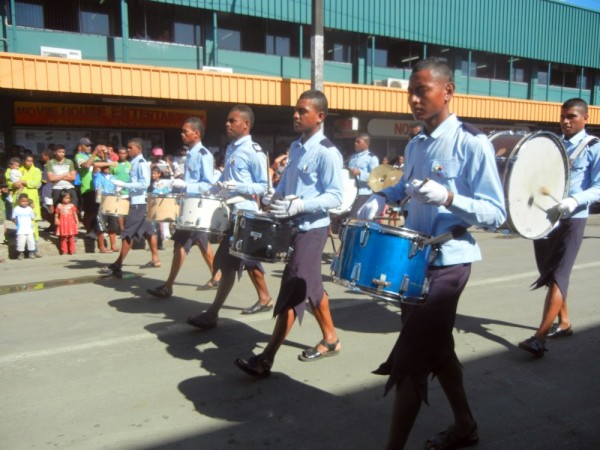 The local drum corps marching in the parade.