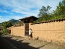 A brick fence and gate surround a hacienda