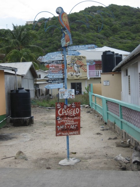 Sign listing all of the shops and their direction in Clifton, Union Island