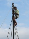 Cliff Massey rigs the mast, hoisted in a more recent harness design, affectionately called a "rigger