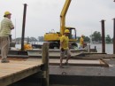 Paul Smith, at left on the dock, oversees as Harbor Dredge & Dock, Marine & General Contractor, stages at Deltaville Marina to dredge the entrance channel.