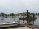 Then uses its shovel to help get the barge moving.