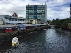 Suva fish market: The local fisherman bring their fresh fish with their boats to the market.  Open tables under a covering on the left of the river.
