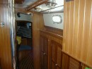 One of the changes I made in the layout was to eliminate a small seat on the starboard side of the main cabin and build in more storage instead.  Two of these lockers were hanging lockers.  One was for foul weather gear and the other for other clothes.  Hanging lockers are useless for clothes storage as the motion of the boat chafes the clothes against each other.  I am in the process of converting both of these lockers to shelved for more accessible storage of things we need easy access to. 