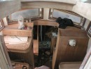 This shows the pilot house interior under construction.  The opaque window coverings have the look of something that was learned the hard way in the past, maybe the time a yard worker tossed a teak plank through a window.
