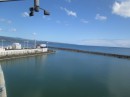 This photo shows the entrance to radio bay which is a narrow pass around the end of the cruise ship dock and just inside the long breakwater that protects Hilo Bay.  When a cruise ship is in port visiting yachts have to pass withing a few meters of the end of the ship to enter radio bay.