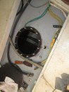 Here is the fuel tank with the inspection plate removed.  The inspection plate is seen in the bottom of the picture.  The hose to the left of the inspection port is for the anchor wash down outlet on deck.  The black rubber hose is the tank vent .  The green wires are part of the bonding system for connecting all the major metal components on the boat together.