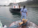 The pilot boat draws closer to pick up Ricardo.  When the advisers board the boat the pilot boat must pull alongside the yacht but when they have the option of using the mooring as a boarding platform they do it that way instead.