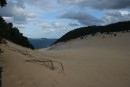 These sand dunes are eating away the rain forest at Rainbow Beach, quite the sight