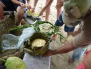 The coconut bread is set to cool and Sikki then took the breadfruit - bottom left corner - to roast on the fire.