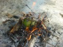 Sikki turned the breadfruit numerous times in the fire and after it had become blackened, he dunked it in the water to cool it.
Then he peeled it and handed it to us on a bed of leaves he