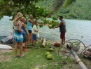 After we asked all our questions and took all our photos, one of the men went next door to a coconut tree and began pulling down green coconuts. He chopped off the tops with his machete. 