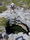 Kim looking one of the natural wells on Warderick Wells Cay