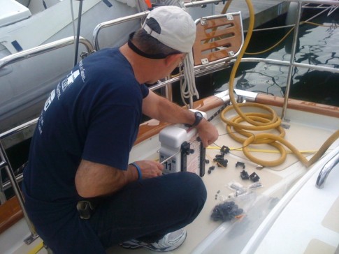 Tom works on mounting our Switlik MOM-8 man over board module. This $725 piece of safety gear is designed to be thrown off the stern after the unfortunate crew member that winds up in the sea.