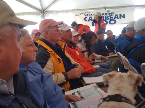 Captains listen intently during a last minute weather and gulf stream briefing. Even the dog in the foreground seems to be paying close attention.