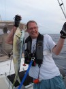 Dennis poses with the Mahi Mahi. Moments later, the fish succumbed to a couple of shots of tequila poured over it