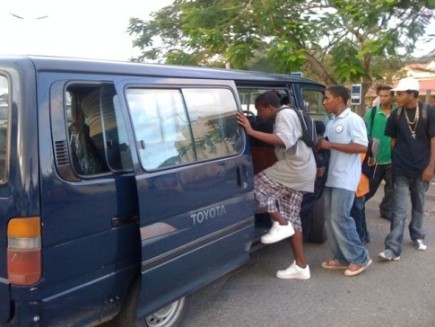 Locals pile aboard a bus in Marigot. It