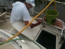 Aaron helps clean the topsides around the aft starboard lazerette.