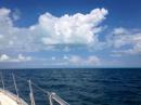 Cat Island sail: Approaching Cat Island, where the water is so blue, it reflects onto the bottoms of the clouds.