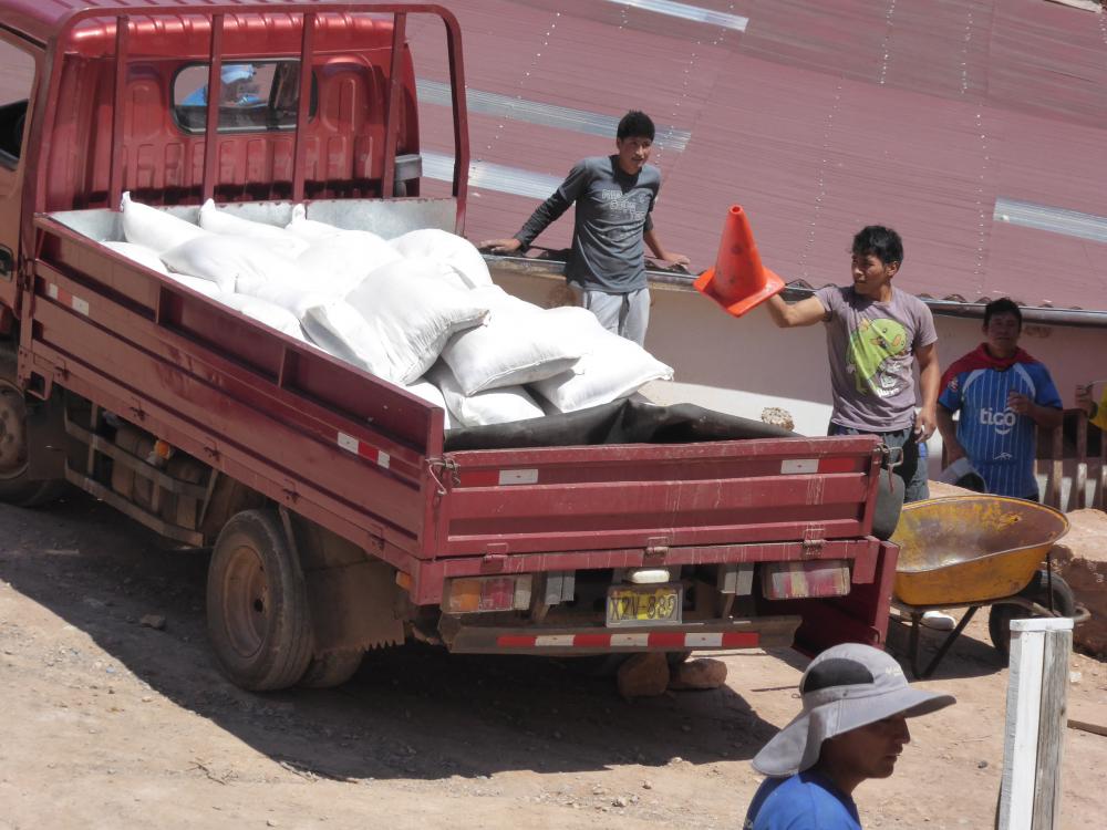 Salt farmers loading up their truck with bags of salt
