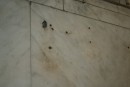 bullet holes in museum wall